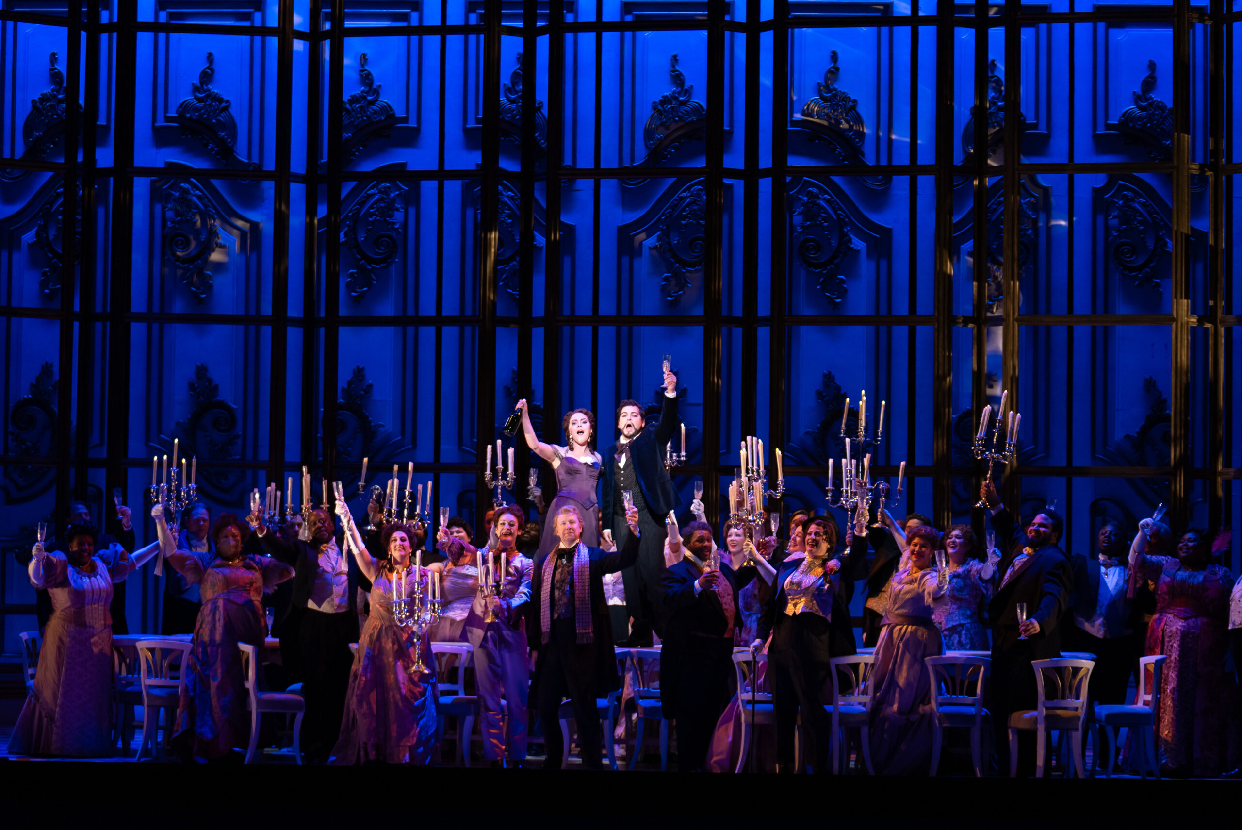 Soprano Emily Pogorelc as Violetta and tenor Galeano Salas as Alfredo (center), with the Detroit Opera Chorus, in Detroit Opera’s La traviata, directed by Francesca Zambello and conducted by Roberto Kalb, October 19, 25, and 27 2024. Photo by Austin Richey / Detroit Opera