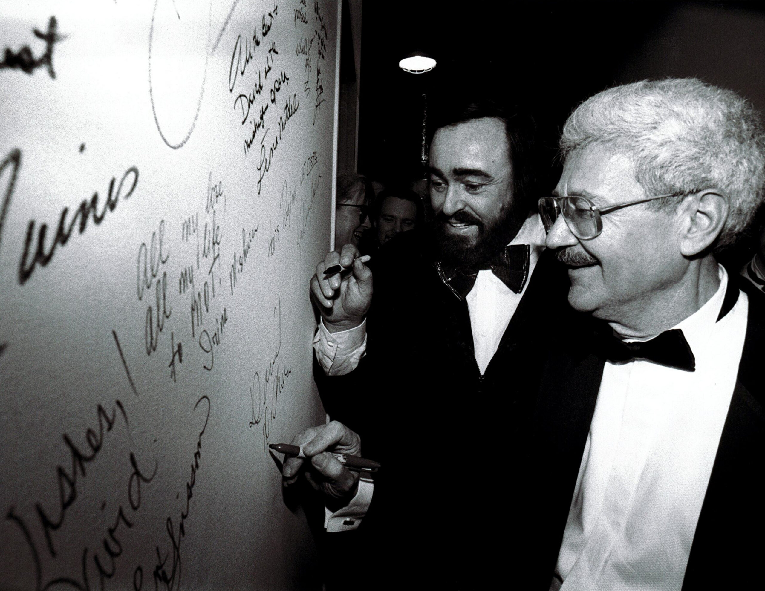 Pavarotti and DiChiera sign the walls of the Detroit Opera House