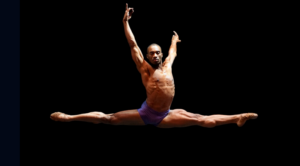 Desmond Richardson in mid-leap during a dance production by Complexions Contemporary Ballet